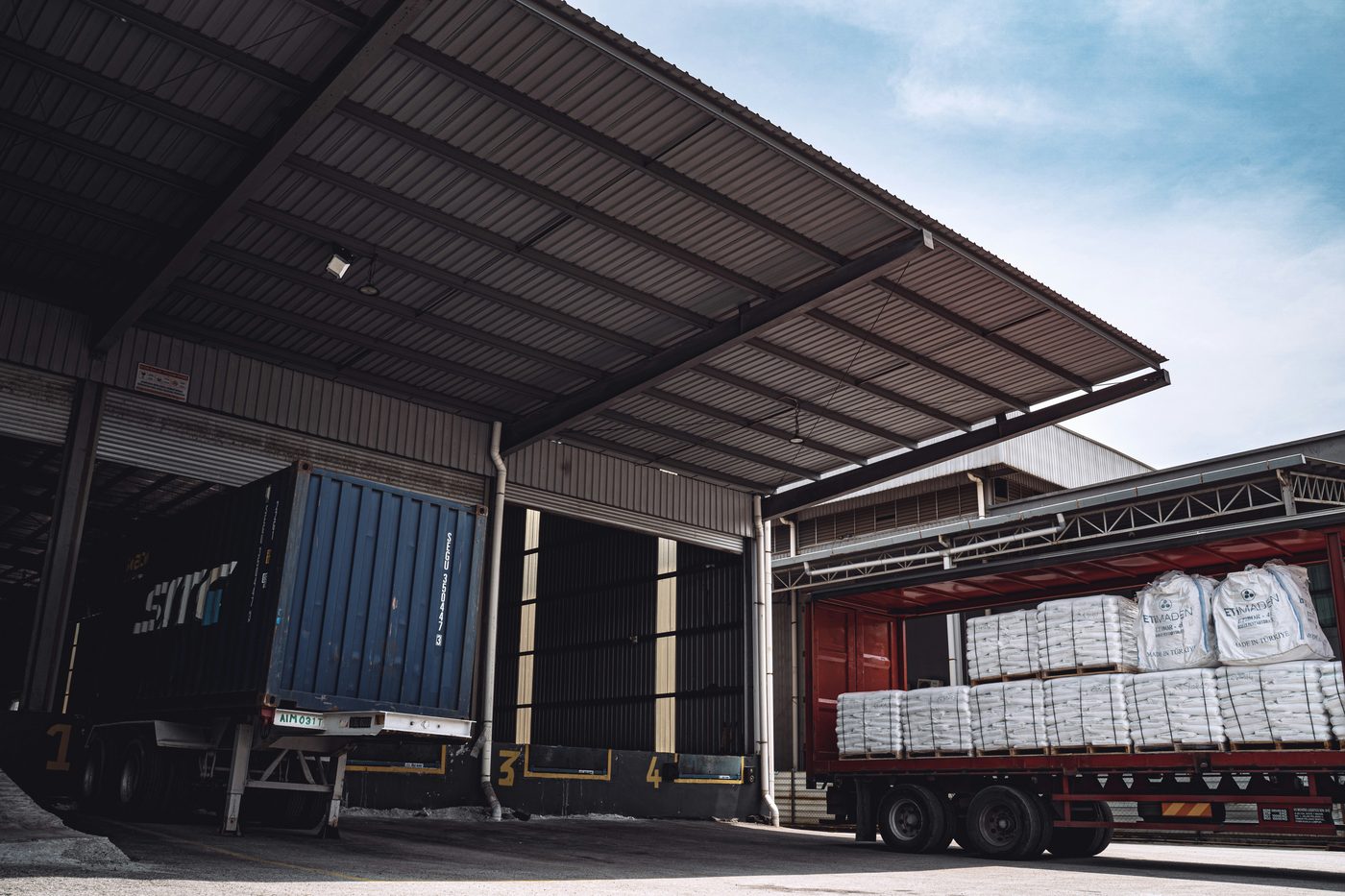 Freight loading area with trailers and packaged cargo